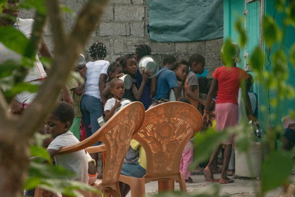 I remember watching the TV series Rin Tin Tin back when I was a lad. I don’t remember much, except that many episodes ended with the sound of the bugle and the cavalry galloping in just in time to save the day. I think I had a naive expectation that an intervening international force could charge into Port-au- Prince, eliminate the gangs and open the streets and highways so that needed fuel, food, and medicine could be delivered. It doesn’t appear that anything like that will happen. It’s all too complicated. No one can predict when schools will be able to reopen. In a conversation with the provost of AUC yesterday, I said it is a tragedy for students to be out of school so long, then the provost said that it is a catastrophe. I am heartsick seeing what is happening in Haiti. But we were able to do a Kid Feed in Sou Wòch yesterday. My mason-crew boss has been learning how to use a design tool on his laptop, and he came up with this rendering with input from Hertha, me and others. He figures that the total cost for demolition and rebuilding the old house of Madam Elvie will be around $30,000. The expanded kitchen could then be used for more than Kid Feed and be a benefit to the community. After buying what we needed for yesterday’s Kid Feed, Hertha told me that prices were still going up and the availability of food was going down—less food for higher price. For many Haitians, the situation is grim and approaching dire. Again, a big THANK YOU! to those of you who are contributing to Kid Feed. A few photos from yesterday: